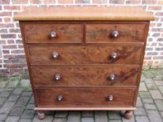 Victorian flame mahogany chest of drawers with turned knobs on ball feet