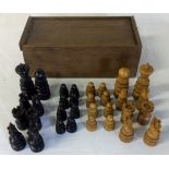 Carved wooden chess pieces in a box