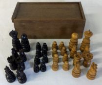 Carved wooden chess pieces in a box