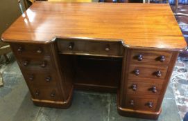 Victorian mahogany breakfront desk with central drawer with cupboards either side fronted by false