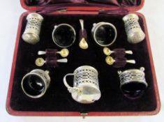 Cased 7 piece silver and blue glass condiment set Chester 1905