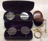 9ct gold monocle on a 9ct gold chain with wooden case & 2 pairs of gold plate spectacles