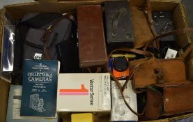 Various vintage cameras and accessories including flashes, lenses,