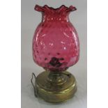 Late Victorian brass oil lamp with cranberry glass shade H 37 cm