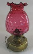Late Victorian brass oil lamp with cranberry glass shade H 37 cm