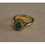 18ct gold emerald and diamond cluster ring,