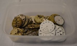 Various pocket watch spare parts including movements and dials