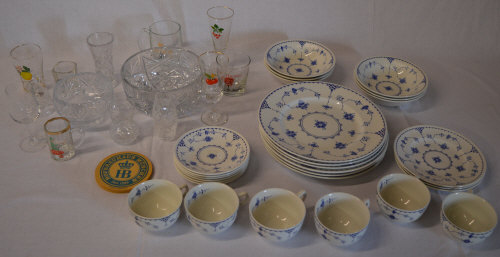 Various glassware including branded drinking glasses and a part tea/dinner service
