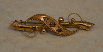 An attractive 9ct gold gypsy set diamond and emerald bar brooch, Chester 1911,