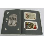 Postcard album containing vintage greetings cards