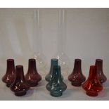 2 glass oil lamp chimneys and various small coloured glass chimneys