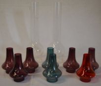 2 glass oil lamp chimneys and various small coloured glass chimneys