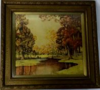 Framed watercolour of a wooded landscape with a river in the foreground signed H B Cross.
