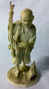 Meiji period carved ivory Japanese okimono of a farmer with a chicken.