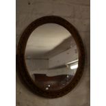 Oval gilt framed wall mirror