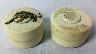2 early 20th century lidded ivory pots with carved tiger decorations. Approx. height 4.