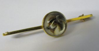 Tested as 15ct gold reverse crystal ingalio stock pin of a collie dog (slight discolouration to ear