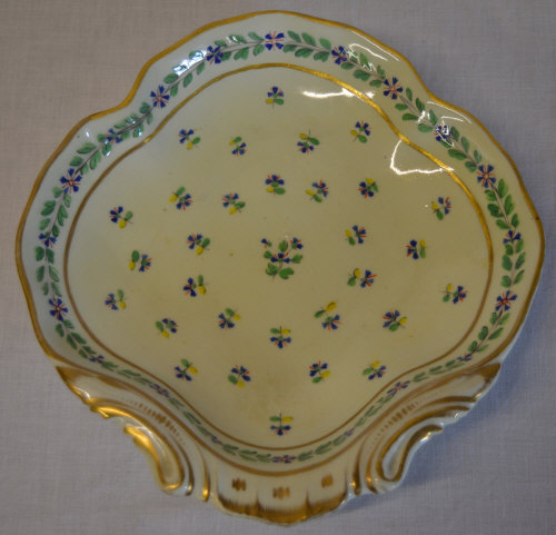 Derby shell dish decorated with small blue flowers and green/yellow leaves,