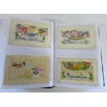 Postcard album containing approx 73 silk embroidered postcards and other cards relating to the war