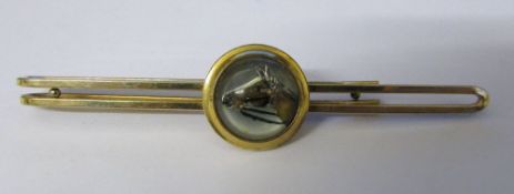 Gold plated reverse crystal intaglio tin clip depicting a horse