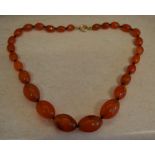 Graduated amber style glass bead necklace with a gold plated clasp