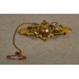Ornate 9ct gold Victorian bar brooch with small central diamond in a gypsy style setting,