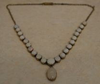 A yellow metal graduated opal drop necklace