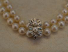 A two row pearl necklace with silver and pearl clip