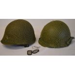2 reproduction USA military M1 style helmets with netting including one marked Levior and a pair of