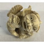 Small Japanese Meiji period ornately carved ivory okimono depicting 2 foo dogs