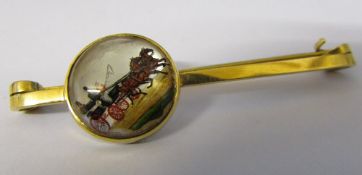 Tested as 15ct gold reverse crystal intaglio stock pin of a horse and carriage (chip to edge) total