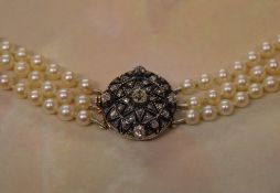 A late 19th century / early 20th century three row graduated pearl necklace with a tested as 9ct