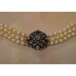 A late 19th century / early 20th century three row graduated pearl necklace with a tested as 9ct