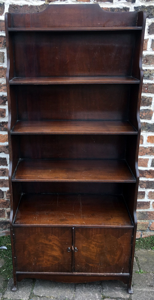 Regency style waterfall front mahogany bookcase