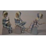 Set of three Lladro harlequin figures perched on bases titled A, B,