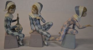 Set of three Lladro harlequin figures perched on bases titled A, B,