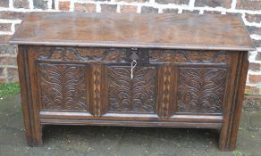 Late 17th century oak coffer with ornate carving on stile legs with internal candle box W 122cm D