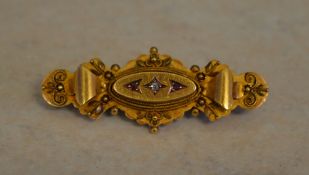An Edwardian 15ct gold diamond and ruby bar brooch, Chester 1903, total approx weight 4.