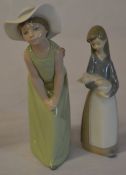 Lladro figures 'Curious Girl with Hat' and a young girl holding a piglet