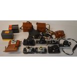 Various vintage cameras including Zenit, Kodak,