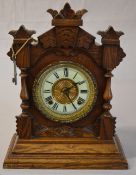 An Ansonia mantle clock with white dial