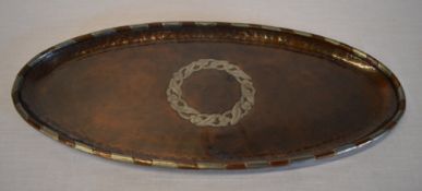 Arts & Crafts copper and pewter banded oval dish with central knot motif,