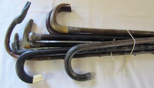 Assorted walking sticks and canes some with silver mounts