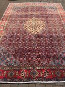 Large red & blue ground Persian carpet with traditional senadash design 310cm by 210cm