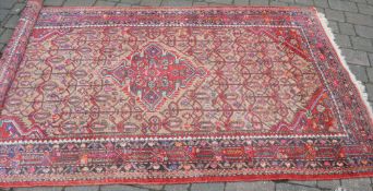 Red ground Persian rug 257 x 145cm