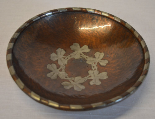 Arts & Crafts copper and pewter banded bowl with central clover motif,