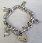 Silver charm bracelet with white metal charms total weight 1.