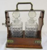 Tantalus with two glass decanters
