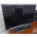 Samsung LED TV with remote control and instruction manual
