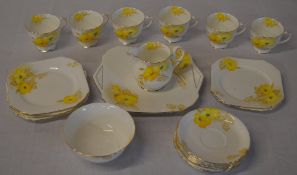 Shelley part tea service decorated with yellow flowers and a gilt rim